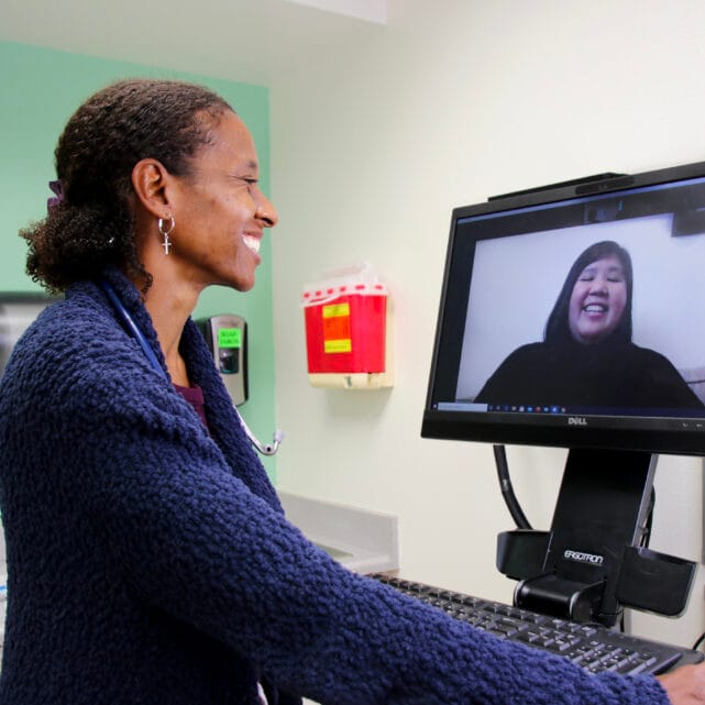 Two women participating in a telehealth call.