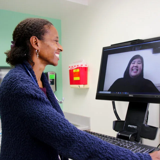 Two women participating in a telehealth call.