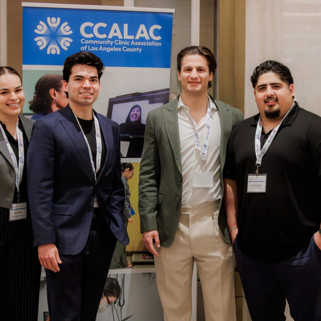 Group of professionals in front of a CCALAC banner.