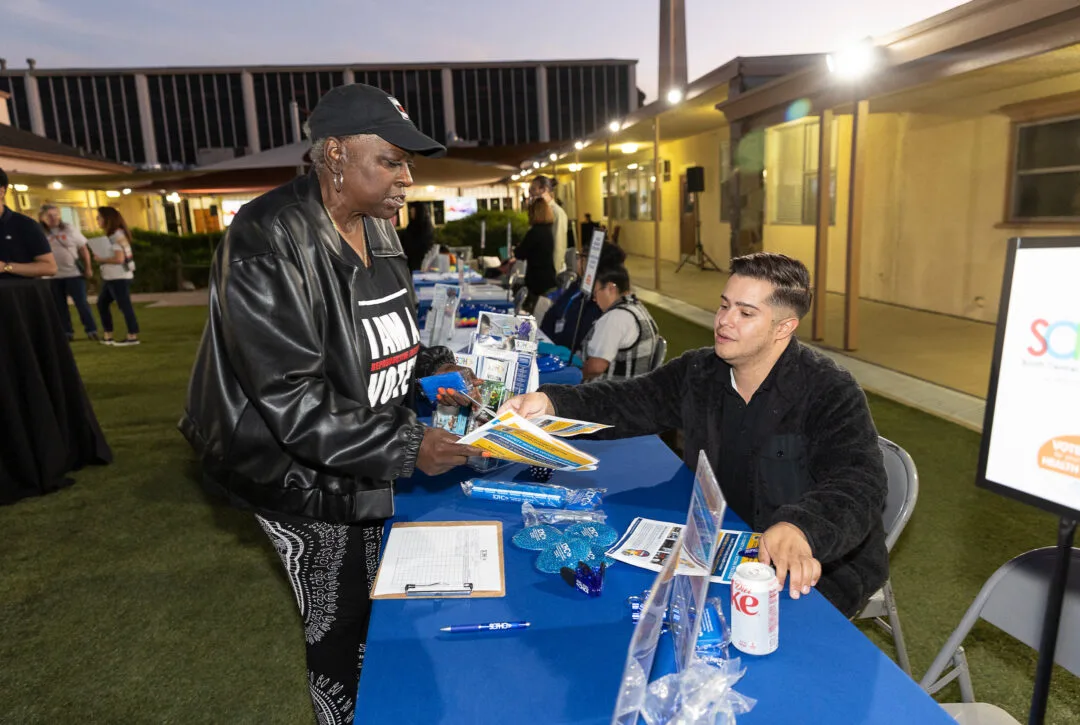 CCALAC staff handing out resources.